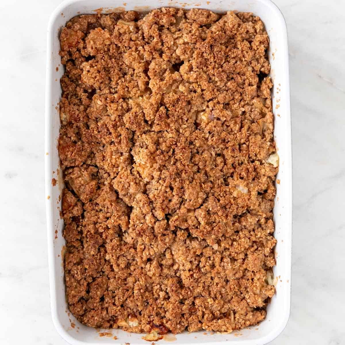 Baking dish with vegan apple crisp after baking.