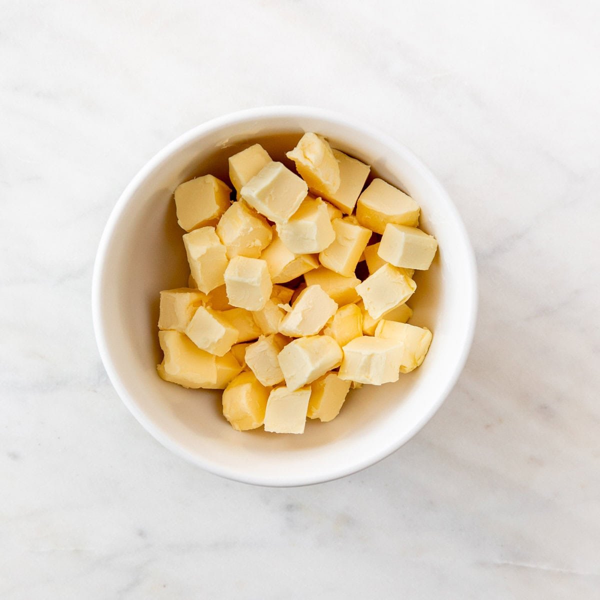 Cold vegan butter cubes diced in a bowl.