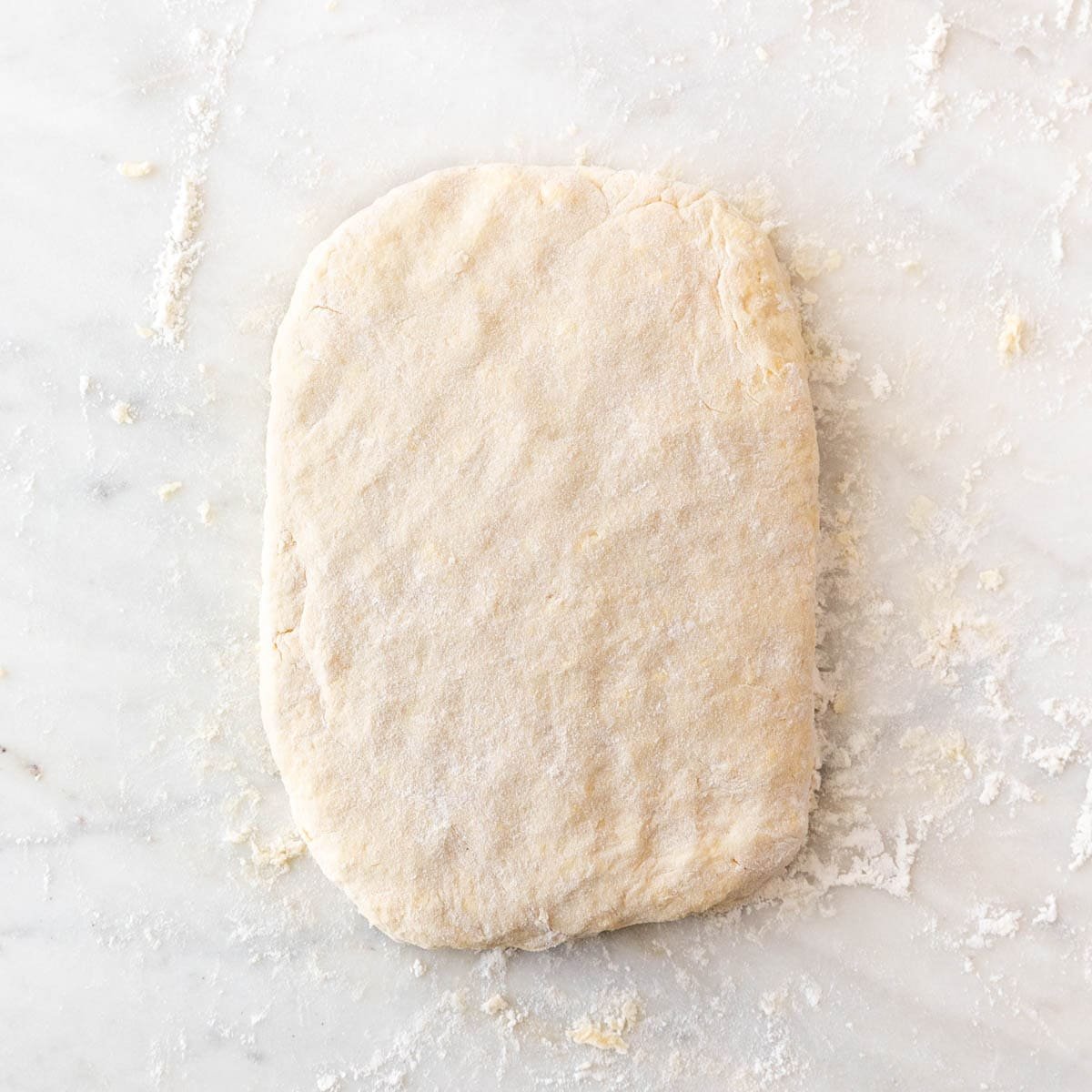 Biscuit dough ready for cutting after final folding and flattening.