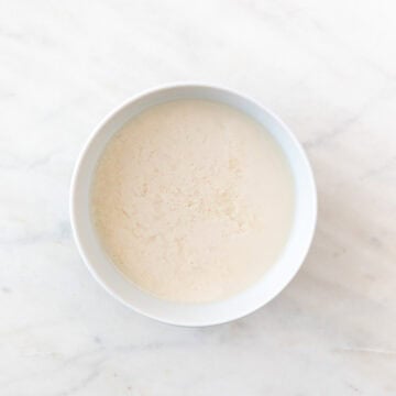 A bowl with non-dairy milk and vinegar mixture.