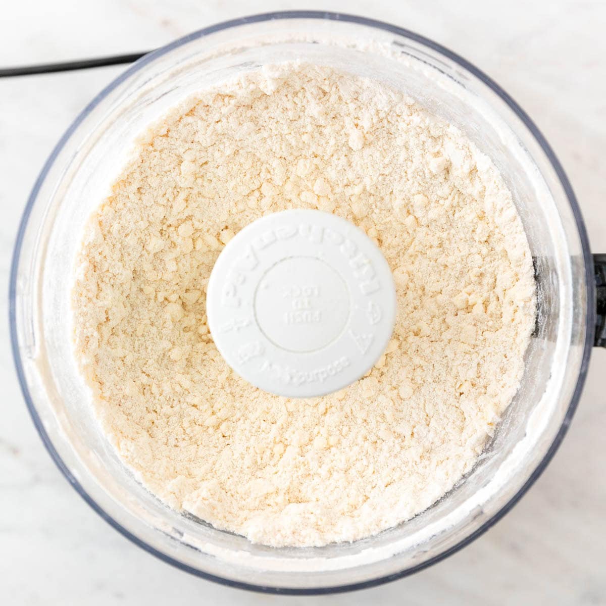 Cold butter cut into flour until the dough resembles coarse crumbs.
