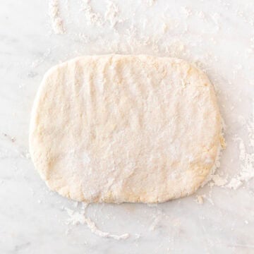 Vegan biscuit dough flattened into a thick rectangle.