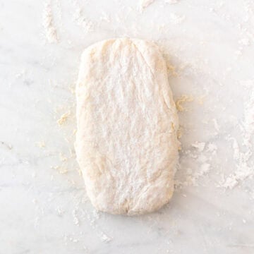 Folding the biscuit dough to create three flaky layers.