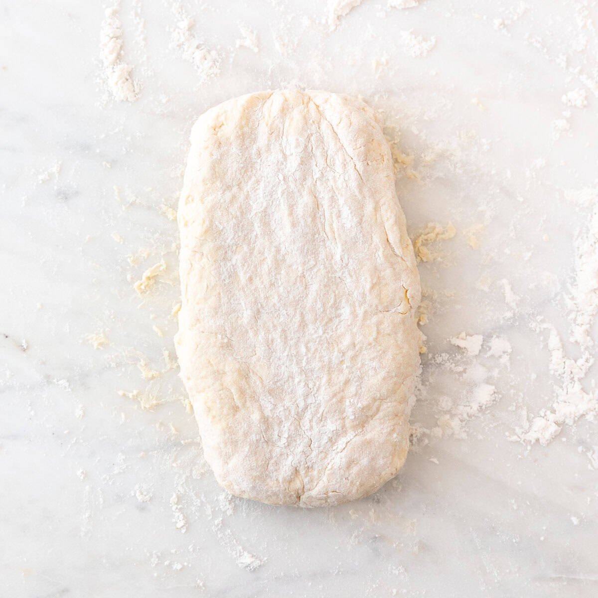 Folding the biscuit dough to create three flaky layers.