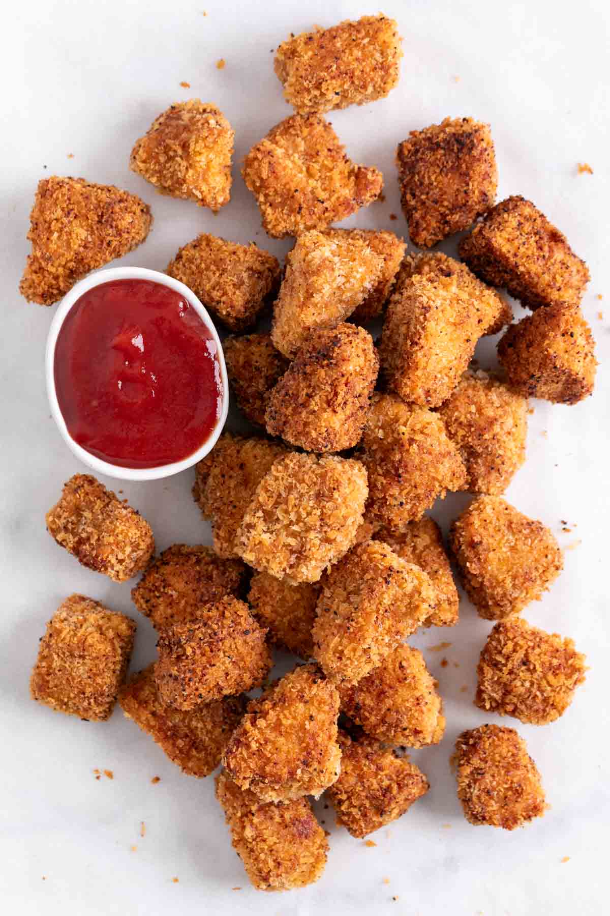 Tofu chicken nuggets with ketchup.
