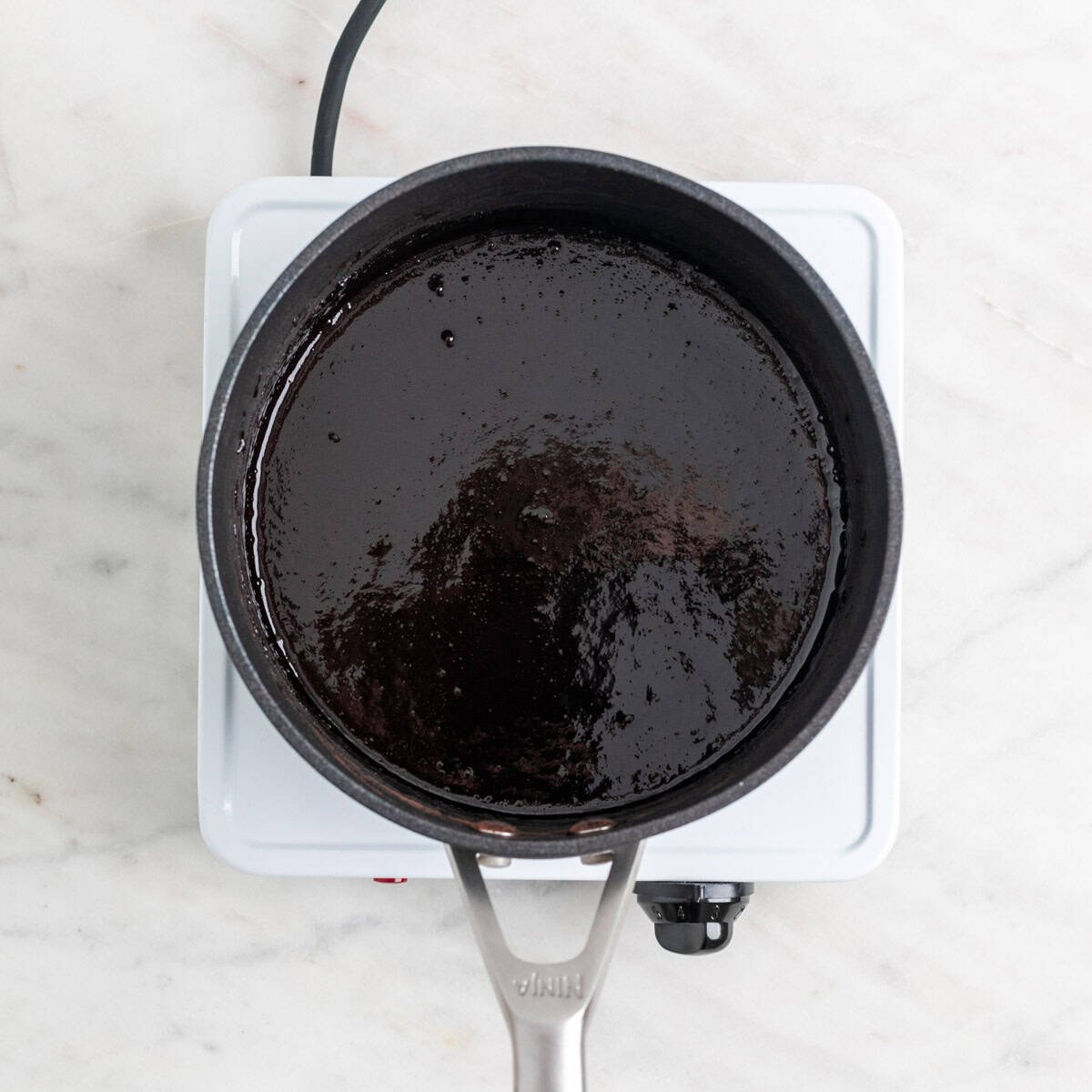 Vegan chocolate sauce in a saucepan.