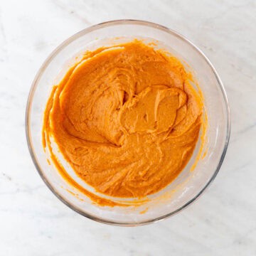 Bowl with vegan pumpkin muffin batter.