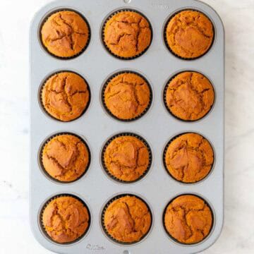 Vegan pumpkin muffins in a muffin pan.