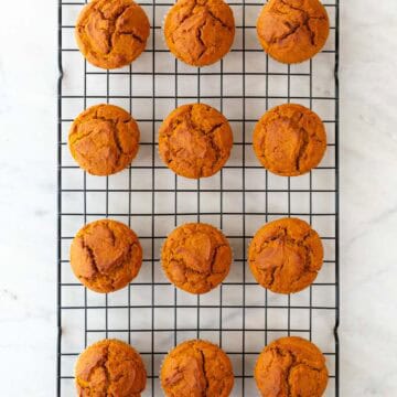 Vegan pumpkin muffins on a cooling rack.