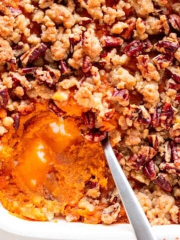 Scooped vegan sweet potato casserole from a baking dish.