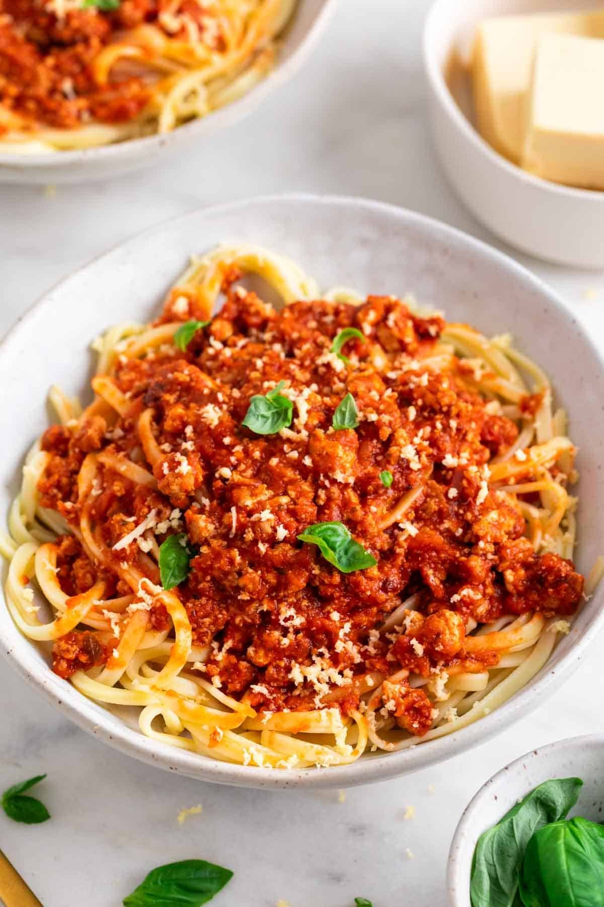 Spaghetti with tofu bolognese, finished with vegan Parmesan and basil.
