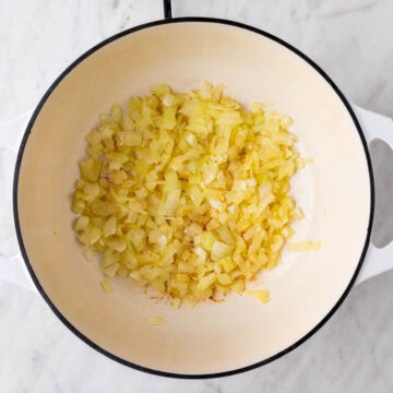 Sautéed onion cooked in a pot until golden brown.