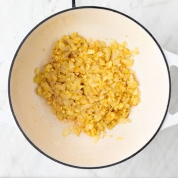 Onion, garlic, and flour cooked together in a pot.