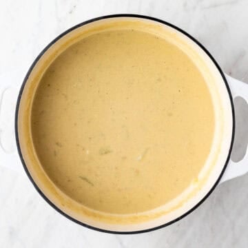 Partially blended vegan potato soup in the pot.