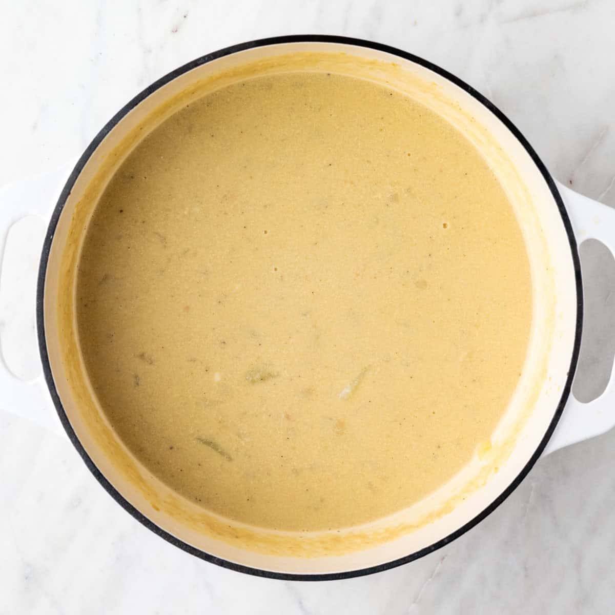 Partially blended vegan potato soup in the pot.