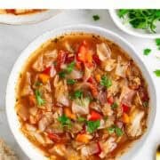 Vegan cabbage soup served with crusty bread.