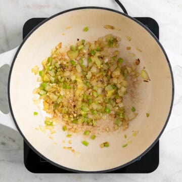 Onion, celery, and garlic sautéed in a pot.