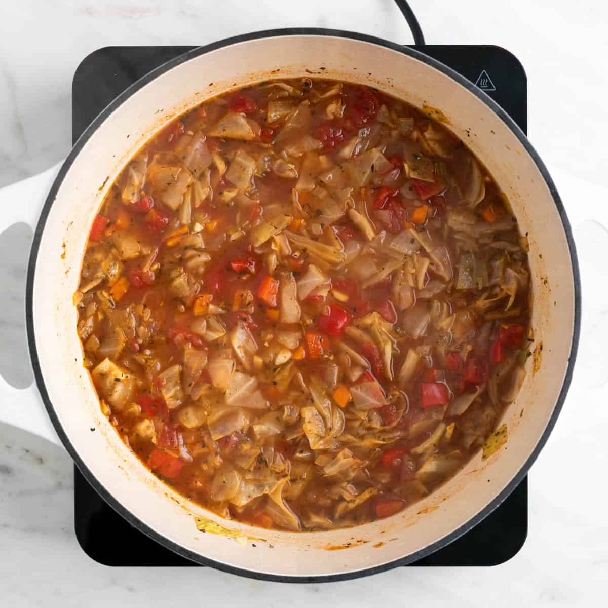 Cooked vegan cabbage soup in a pot.