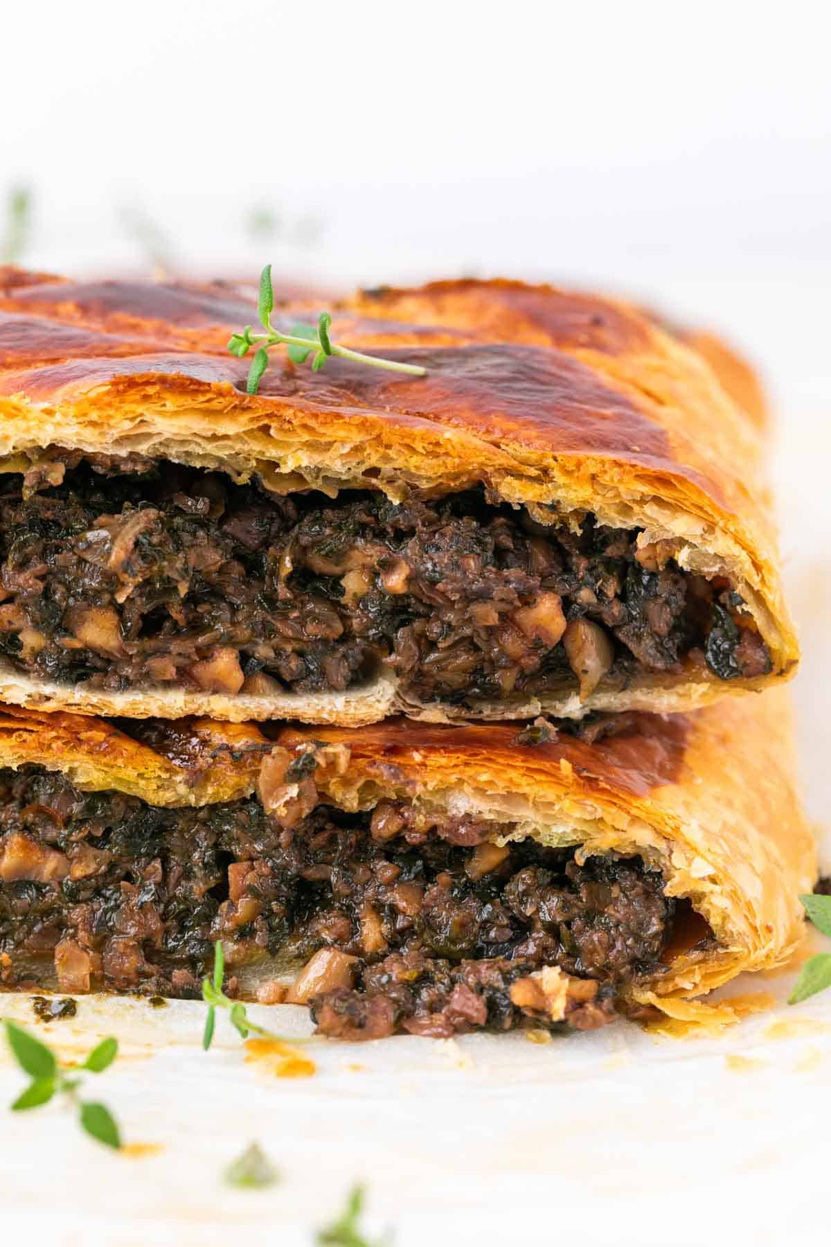Mushroom wellington sliced, showing the layered filling inside.