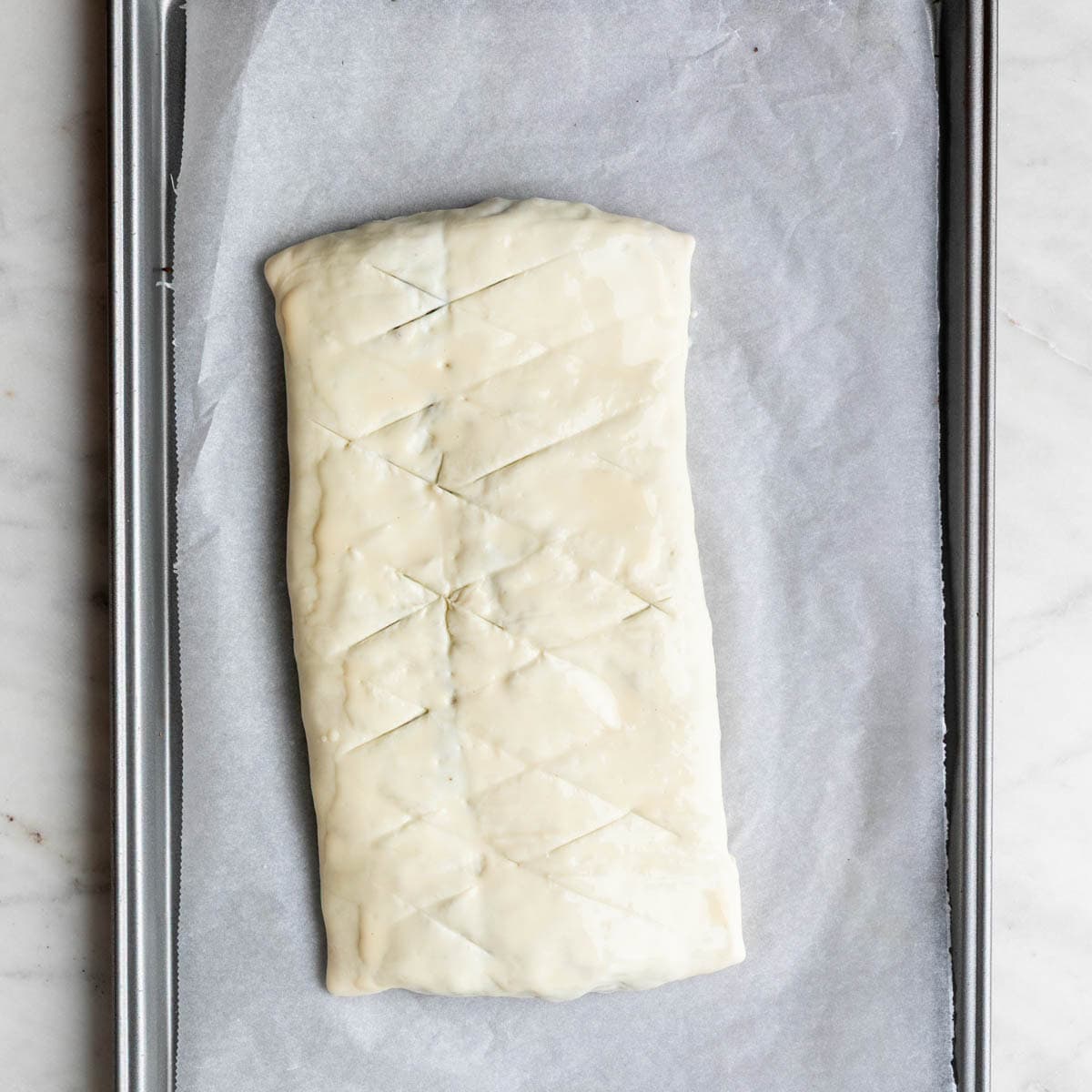 Wellington brushed with plant-based milk and scored on top.