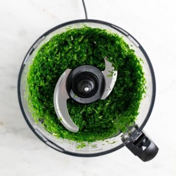 Finely chopped spinach in a food processor.