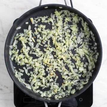 Sautéed onion and garlic lightly browned in a skillet.