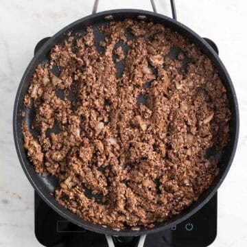 Mushroom and walnut mixture cooking down with reduced liquid.