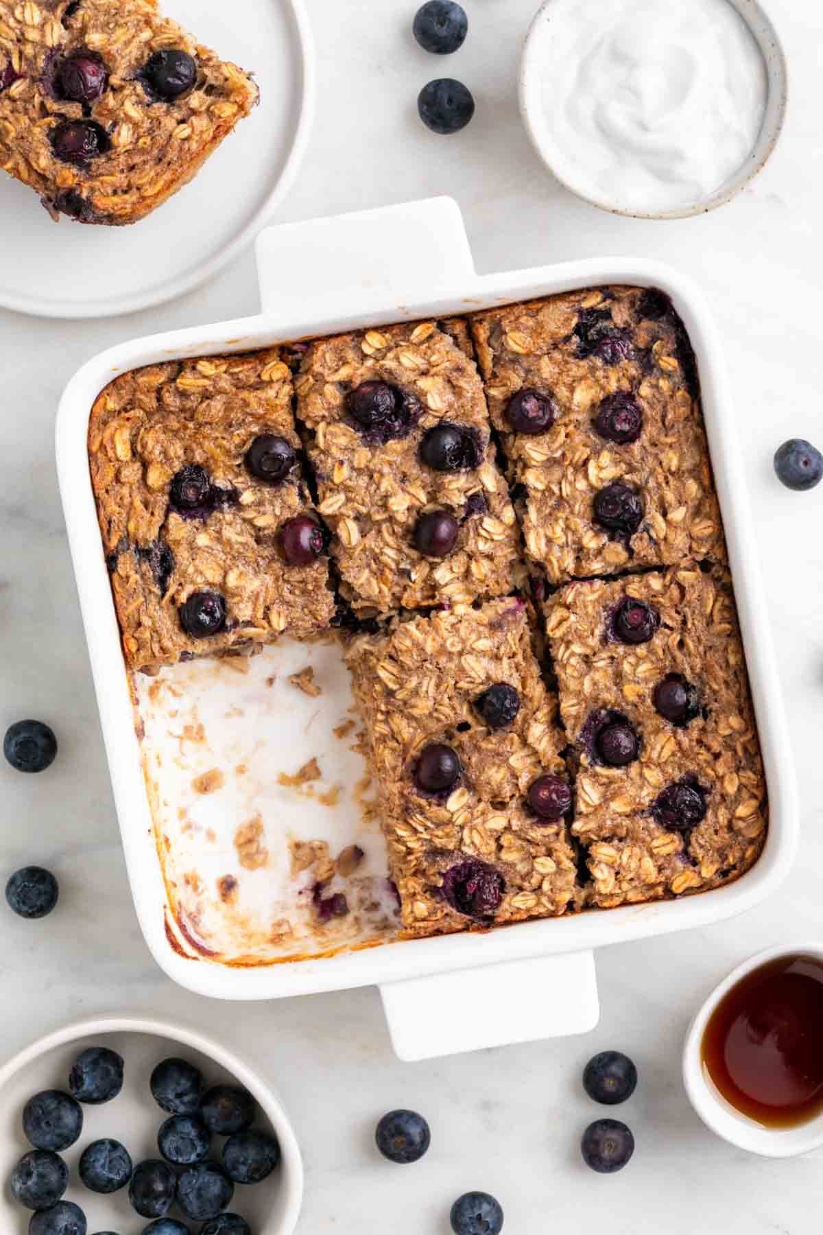 Vegan baked oatmeal cut into squares in a baking dish.