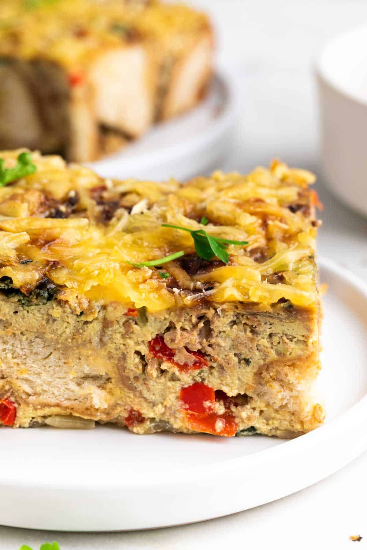 Plated vegan breakfast casserole with parsley garnish.