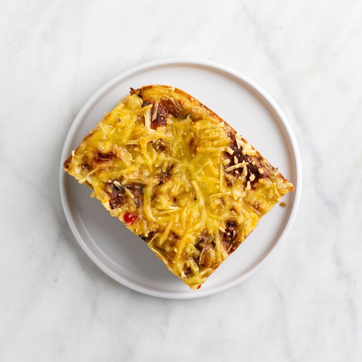 Slice of vegan breakfast casserole on a plate.