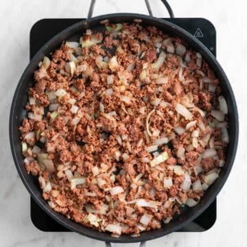 Cooked vegan sausage in a skillet.