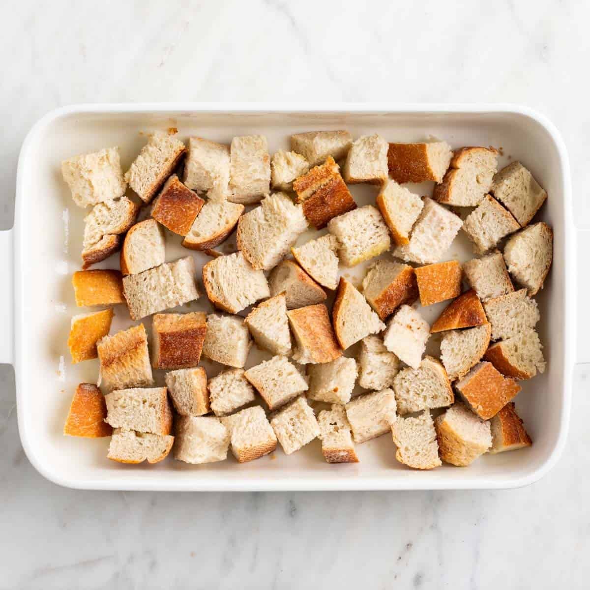Crusty bread pieces in a baking dish.