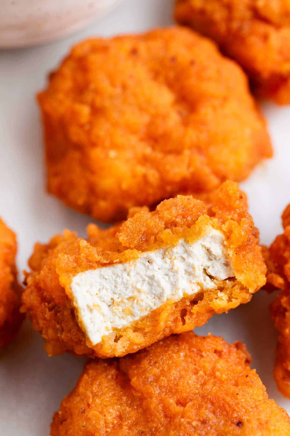 Vegan buffalo wings cut open to show the inside texture.