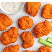 Crispy vegan buffalo wings with blue cheese dressing and celery.