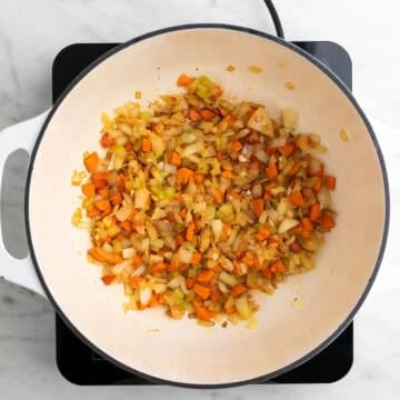 Onion, celery, carrot, and garlic sautéed in a large pot.