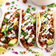 Homemade baked tofu tacos with fresh toppings and vegan sour cream.