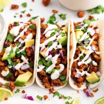 Homemade baked tofu tacos with fresh toppings and vegan sour cream.