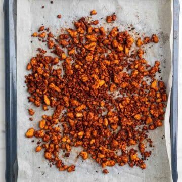 Baked tofu crumbles on a baking sheet.