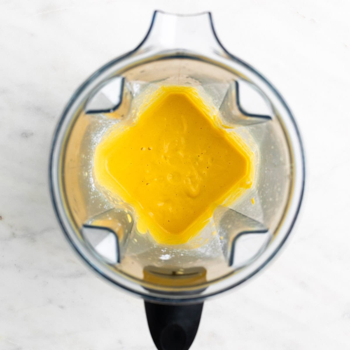 Vegan cheddar cheese mixture in a blender before cooking.