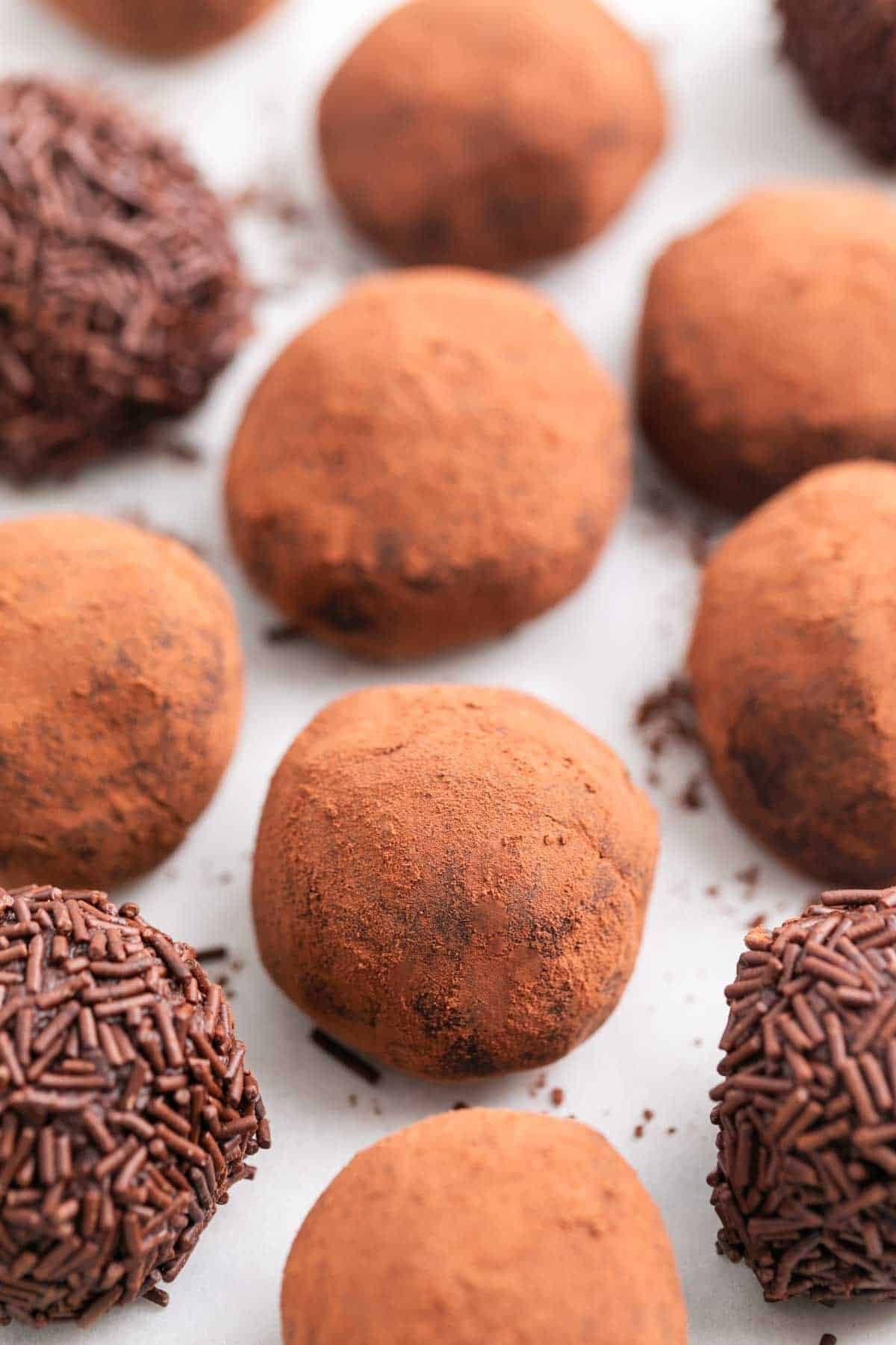 Chocolate truffles with cocoa powder and sprinkles.