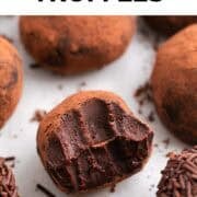 Vegan chocolate truffle with a bite taken out.