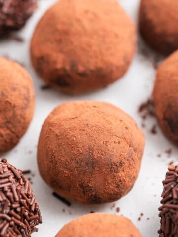 Vegan chocolate truffles with different toppings.