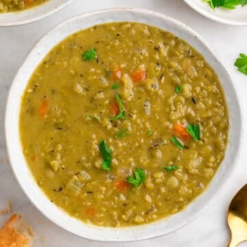 Vegan split pea soup served in a bowl with parsley.