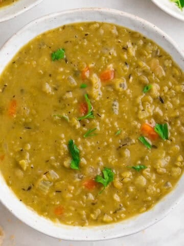 Vegan split pea soup served in a bowl with parsley.