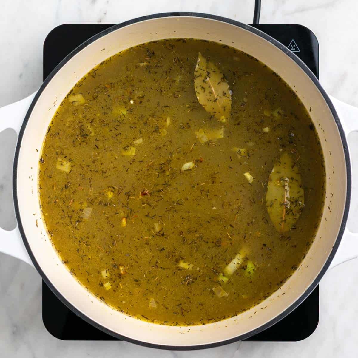 Split pea soup ingredients mixed in a pot.