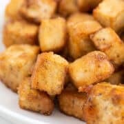 Crispy fried tofu served on a plate.
