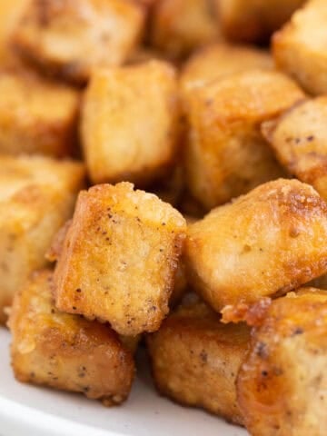 Crispy fried tofu served on a plate.