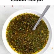 Chimichurri sauce in a bowl with a spoon.