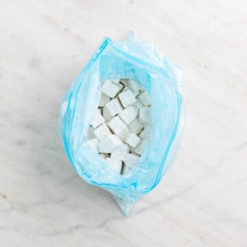 Tofu cubes coated with cornstarch and salt.