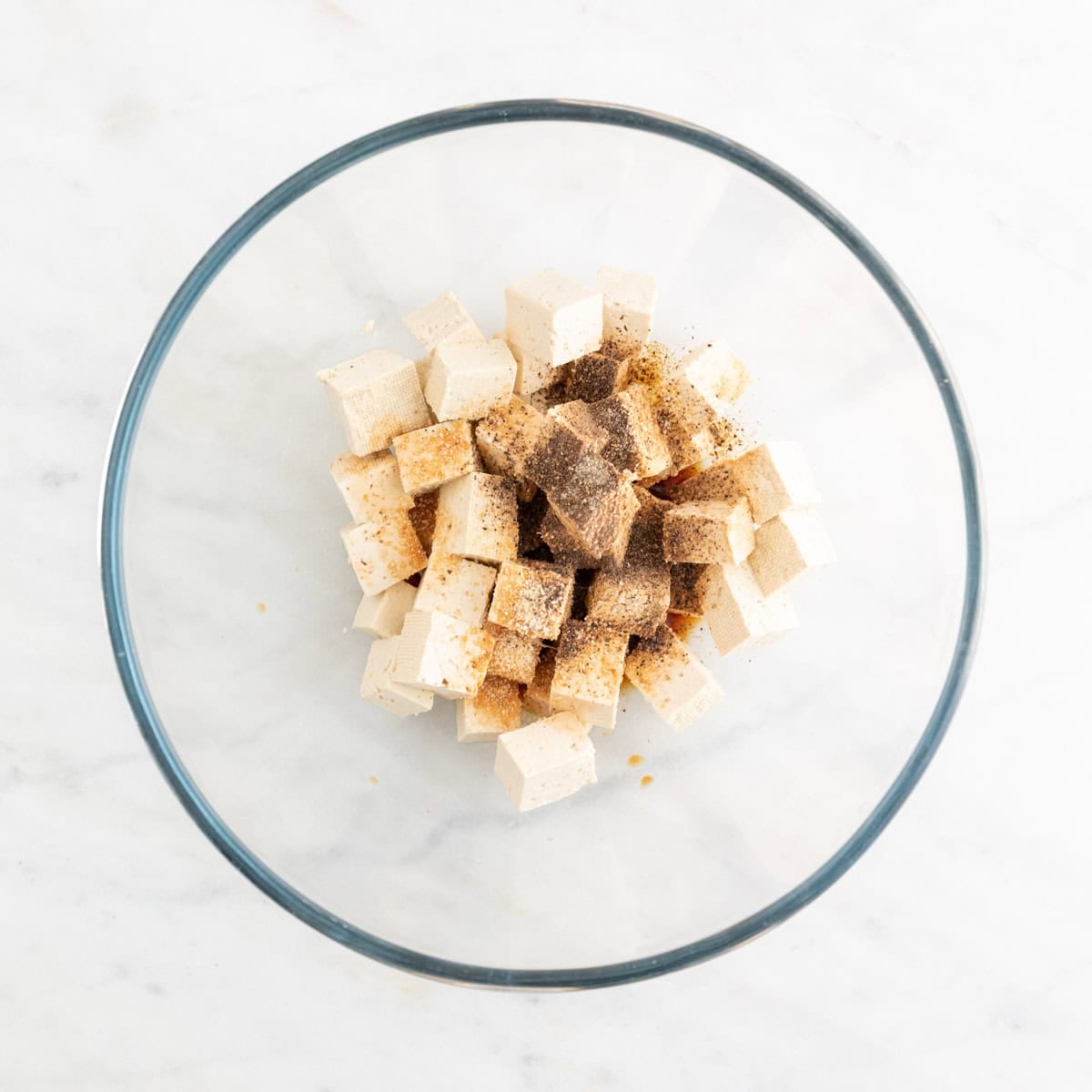 Tofu with soy sauce and spices in a bowl.